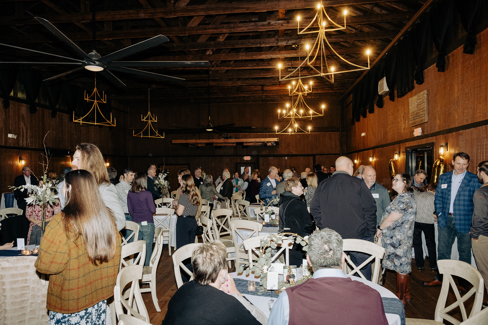 full view of venue filled with guests talking